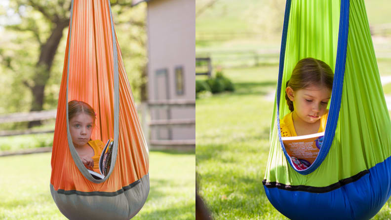 On the left, a young girl suspended in an orange and gray Sky Nook.  Right, a young girl hanging from a green and blue Sky Nook.