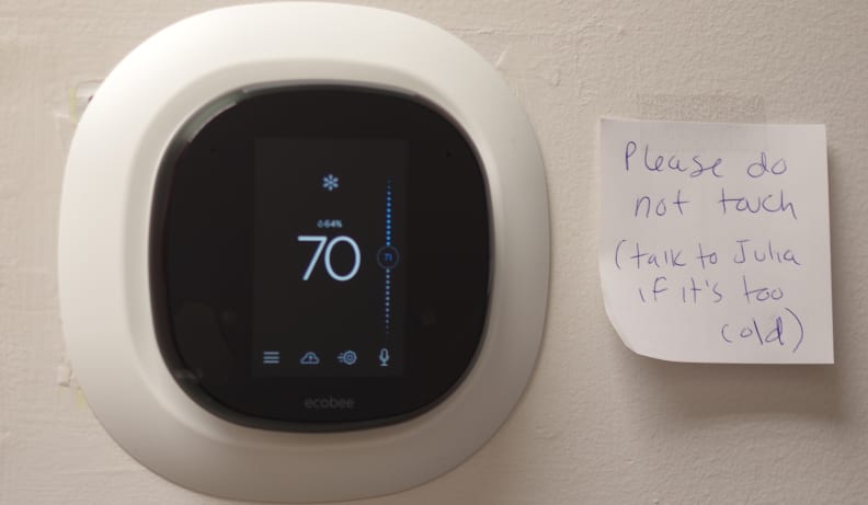 Smart thermostat with a sassy note next to it