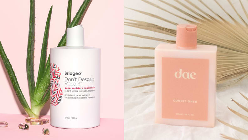 On the left: The white Briogeo Don't Despair, Repair! Super Moisture Conditioner for Dry + Damaged Hair stands on a light pink background and an aloe plant is propped up behind it. On the right: The Dae Daily Conditioner stands on a fluffy white surface and a dried sun palm lays across the background.