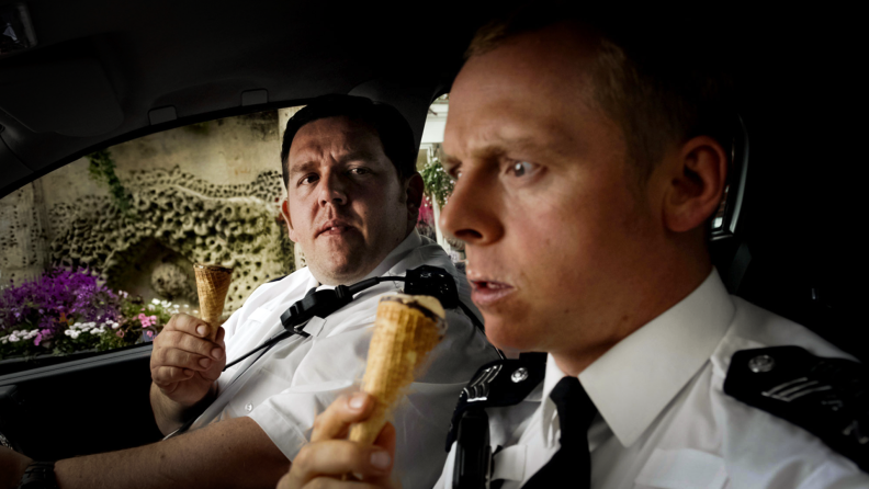 Actors Simon Pegg and Nick Frost are seated in a police car in the 2007 comedy Hot Fuzz.