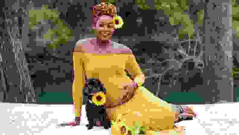 A beautiful pregnant woman and an adorable dog