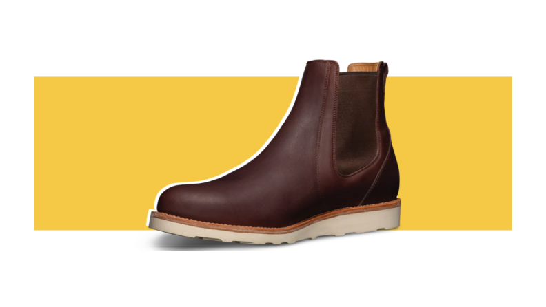 A dark brown Chelsea boot with a low wedge sole and heel.