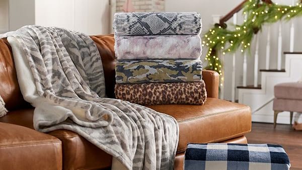 blankets on brown leather sofa