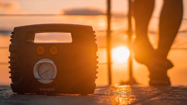 Portable air compressor with sunset in background