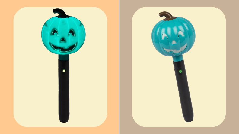 Two small flashlights with black handle and teal jack-o-lantern on top side by side.