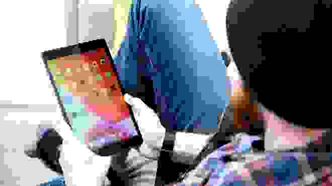 A person holds an iPad.