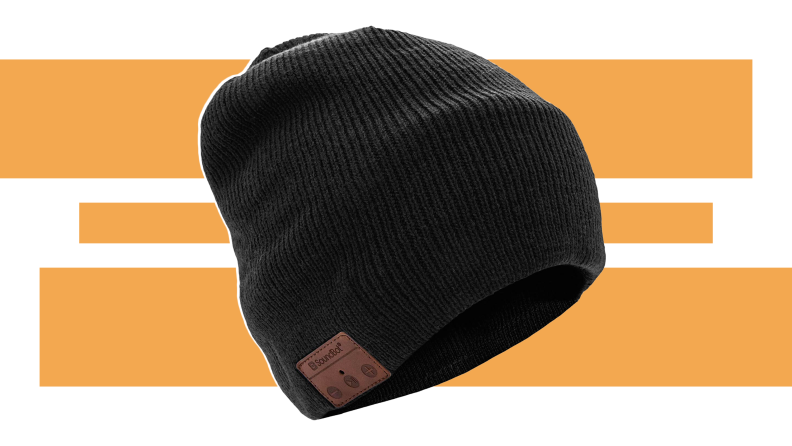 A black SoundBot beanie hovering in front of an orange and white background.