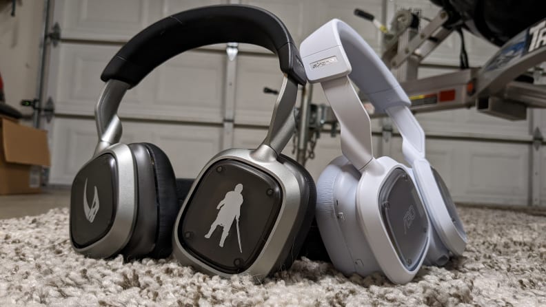 Two Logitech A30 headsets, one grey and one white.
