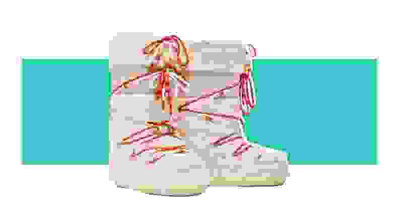 A pair of puffy moon boots covered in white faux fur, with red straps.