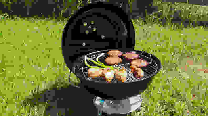 Black portable grill in the grass