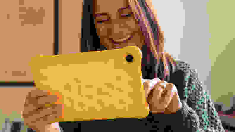 A woman uses an Amazon Kindle Fire tablet