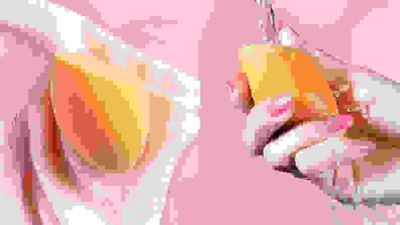 On the left: The orange Real Techniques Miracle Complexion Sponge sits on a light pink towel. On the right: A person holds the orange Real Techniques Miracle Complexion Sponge under a stream of water.