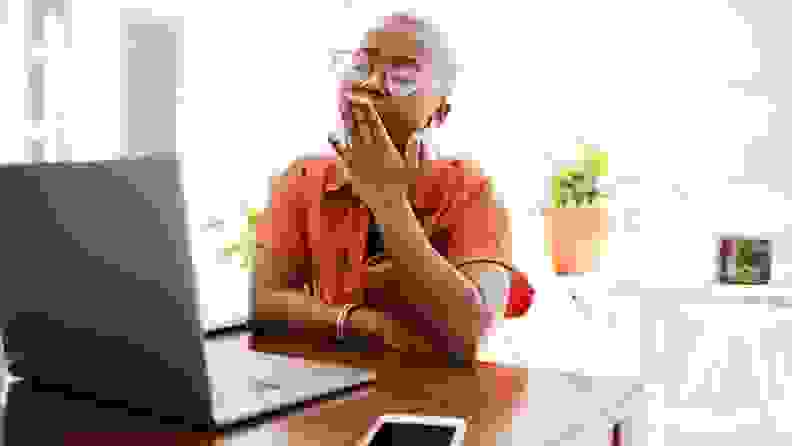 a person sits and yawns by their computer