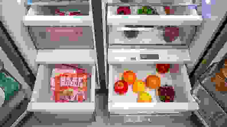 Crisper drawers with fruits and vegetables inside of the Midea MRS26D5AST Side-by-Side Refrigerator.