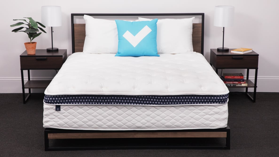 Product shot of the WinkBed Hybrid Mattress in bedroom with pillows on top.