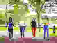 Four women walking in a park