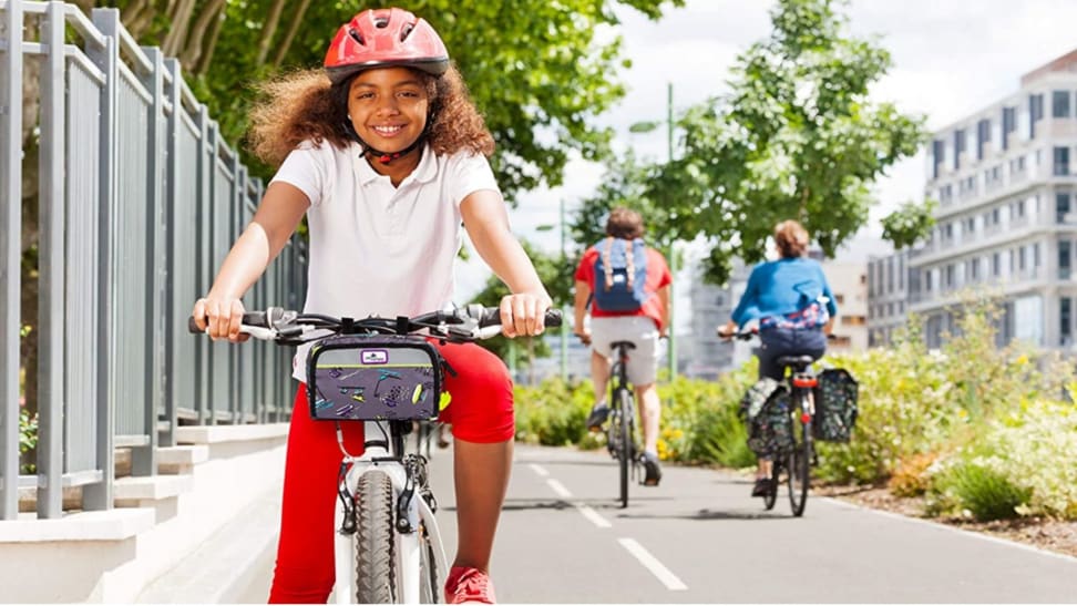 Girl with on a bike wearing a red helmet