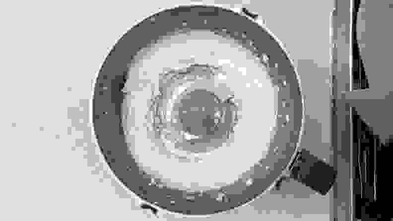 A top-down photo of a food processor filled with whipped feta.