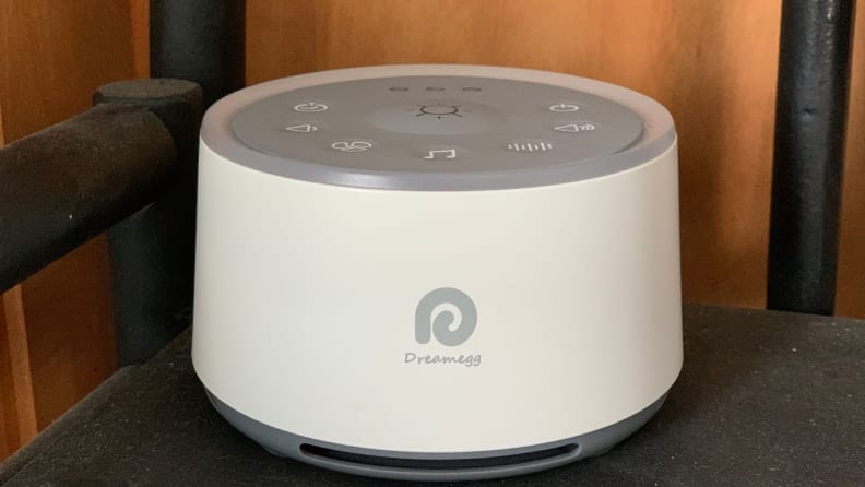 A white Dreamegg sound machine sits on a night stand.