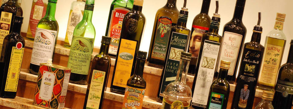 A shelf full of olive oils.