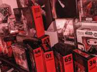 A large collection of Star Wars toys from Hasbro and Funko, most of them in black-and-red Black Series packaging.