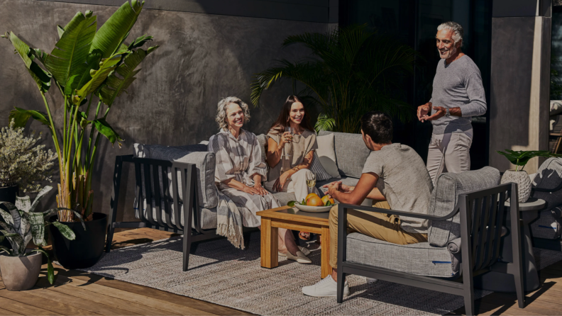 Family enjoying outdoor patio on sunny day.