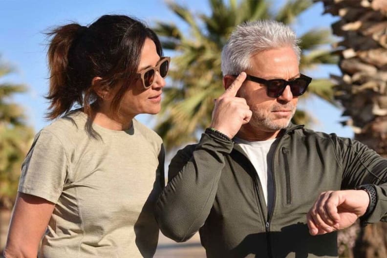 A woman and a man trying out the Adaptive Focus Glasses.