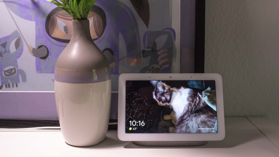Google Home Hub with vase in front of framed art