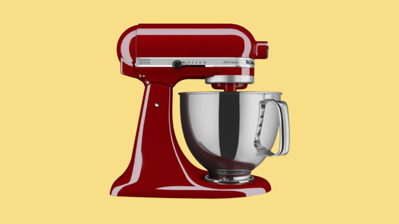 Red stand mixer against yellow background