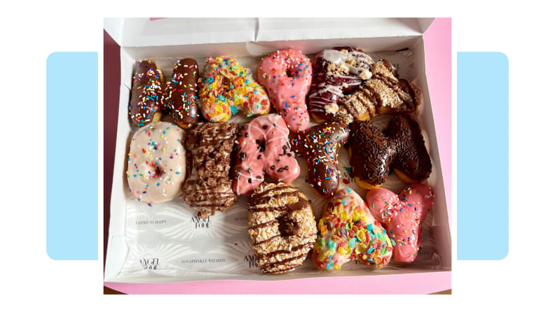 A box of letter-shaped donuts spelling out Happy Birthday in different flavors.