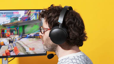 The Audeze Maxwell headset being worn against a yellow background