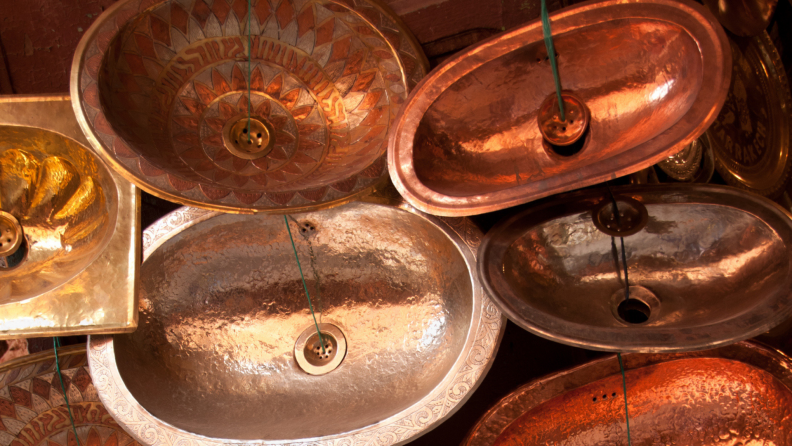 A variety of copper and bronze sinks.