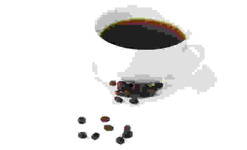 A cup of coffee with beans.