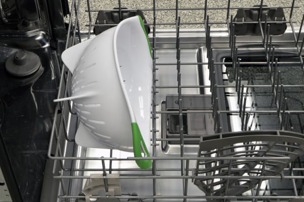A large colander loaded on the lower rack