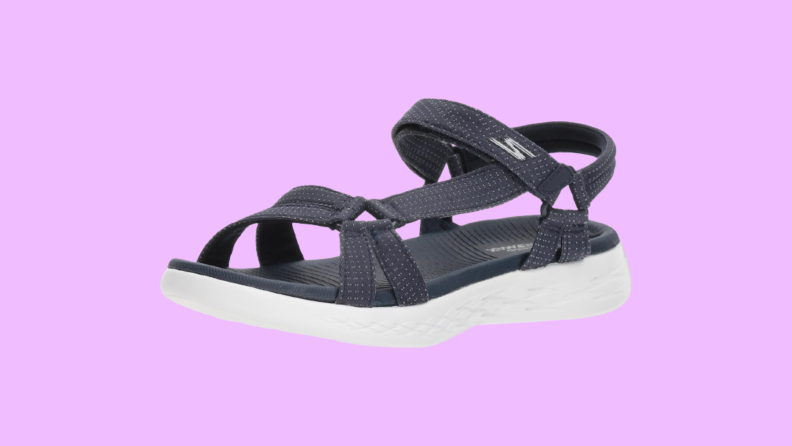Sporty black sandals that feature a low wedge sole.