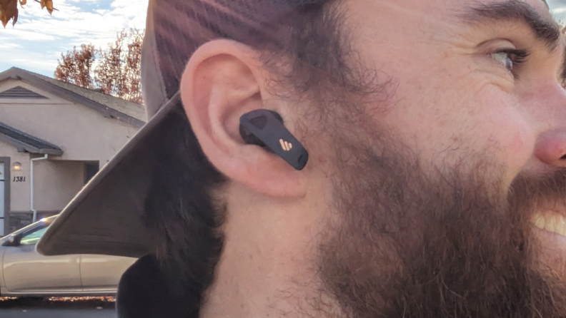 Close-up shot of a man wearing the earbuds