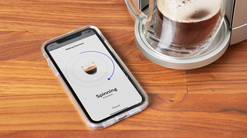 A cell phone shows the Spinn coffee maker app.