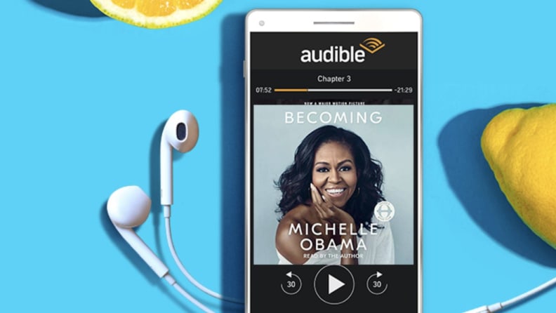 white smartphone with headphones on blue background