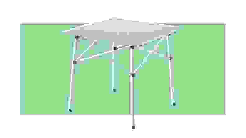A Coleman portable table on a green background.