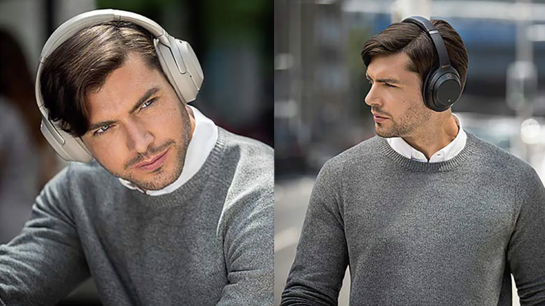A man wearing Sont noise canceling headphones.