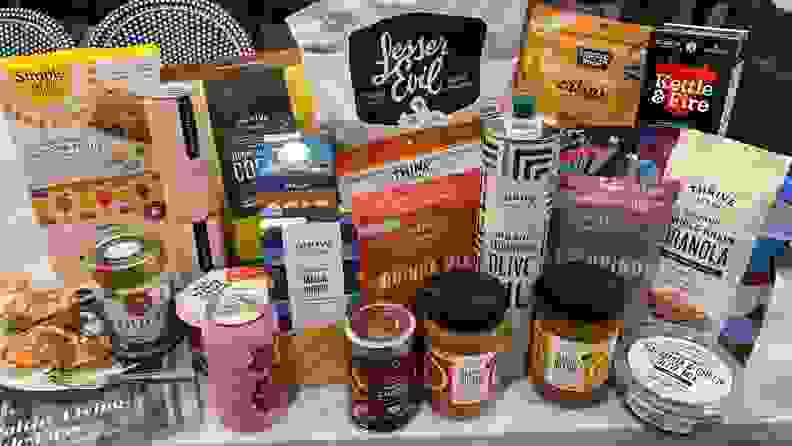 An array of Thrive Market grocery items laid out on a countertop.