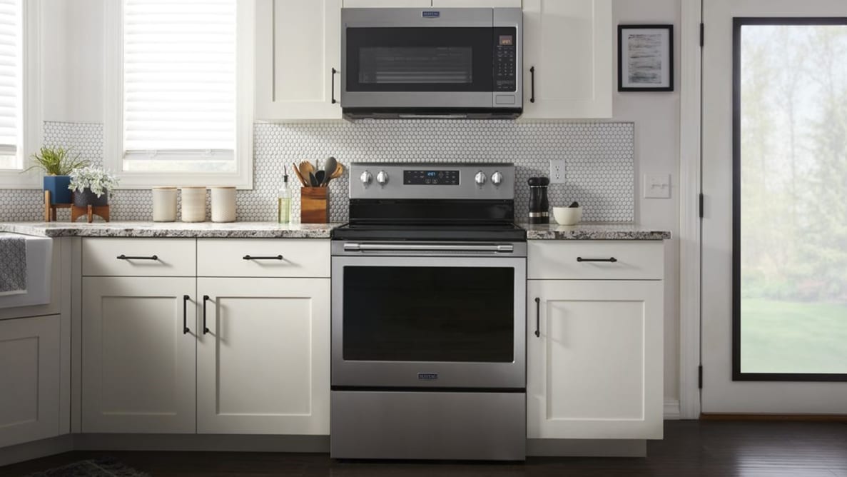 The Maytag MER7700LZ  freestanding electric range in an all-white kitchen.