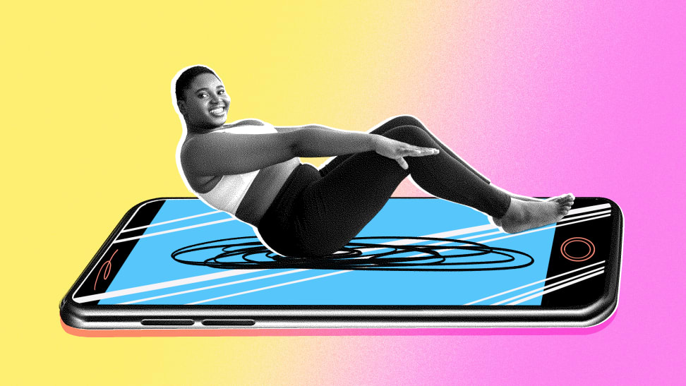 A woman wearing athletic apparel, doing a sit-up on a picture of a large smart phone.