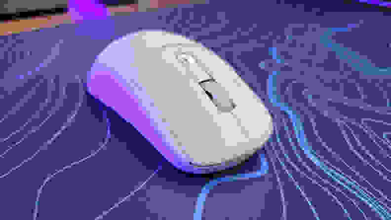 Close up angled view of the Turtle Beach Burst II Air mouse on top of a purple and blue patterned mousepad.