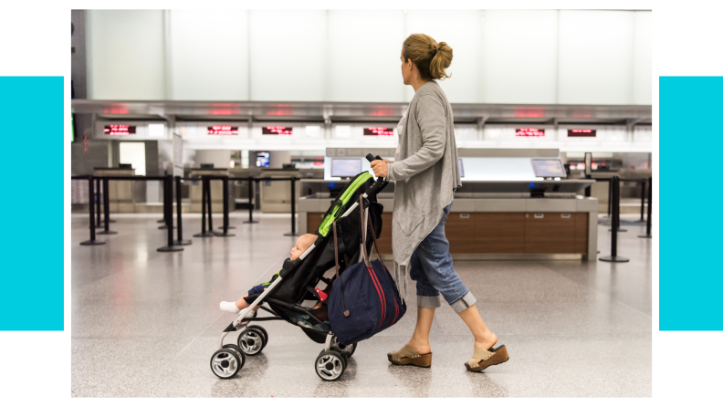 A woman pushing a stroller through an airport