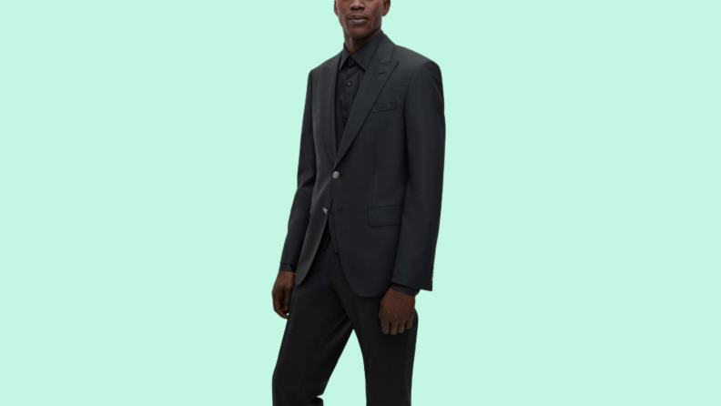A model wearing a black suit.