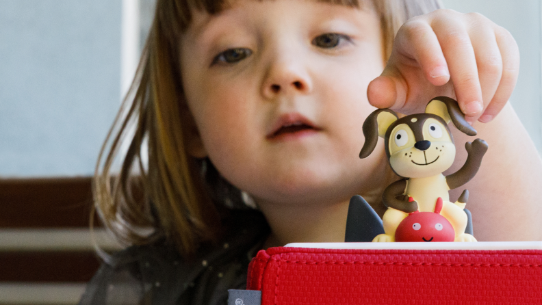 A child plays with a dog Toniebox.