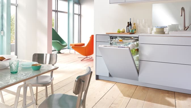 A handle-free kitchen design featuring a Miele Knock2Open dishwasher