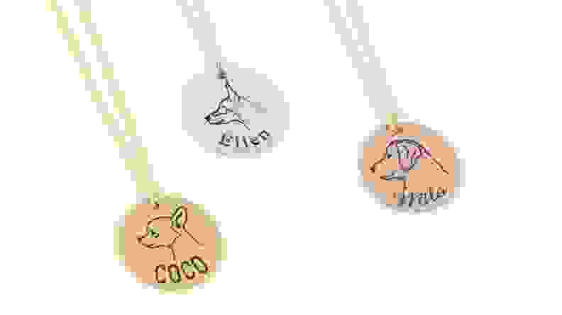 An image of several jewelry pendants featuring dog profiles and names.