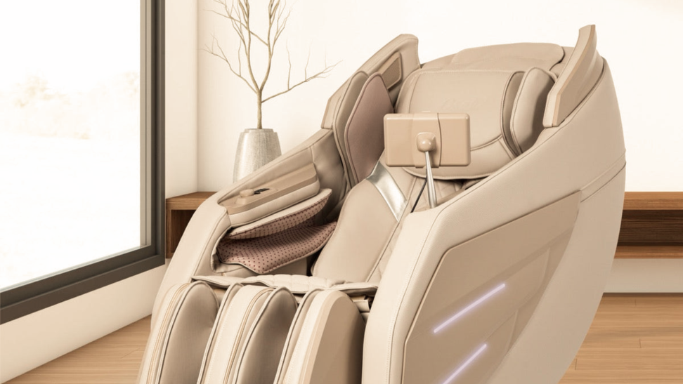 A beige Osaki massage chair on display in a well-lit living space. A decorate potted plant sits behind it.